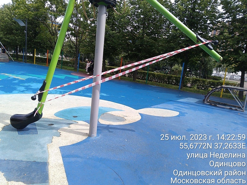 Сломанные качели на детской площадке в парке центральной площади Одинцово, Июль
